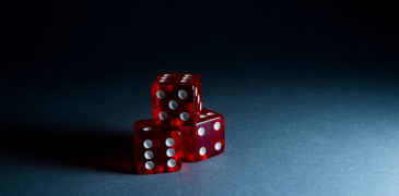 Three red dice with white markings stacked