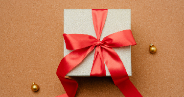 Overhead shot of a gift with a red ribbon