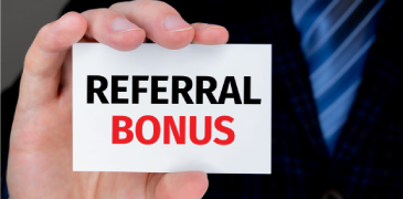 Hand holding a card saying referral bonus