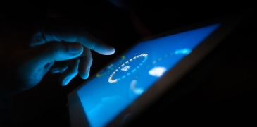 A hand about to click a touch screen mobile device